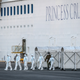 Emergency workers in protective clothing exit the Diamond Princess cruise ship at Daikoku Pier where it is being resupplied on February 10, 2020 in Yokohama, Japan.